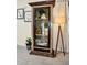 Freestanding display cabinet with glass doors and wooden frame at 7706 Graben St, Kissimmee, FL 34747