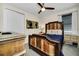 Guest bedroom with a wooden bed frame and neutral color scheme at 7706 Graben St, Kissimmee, FL 34747