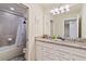 Bathroom with double vanity and granite countertop at 7143 Oakmoss Loop, Davenport, FL 33837