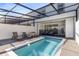 Private screened-in pool and patio area with lounge chairs at 7143 Oakmoss Loop, Davenport, FL 33837