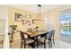 Bright dining room with a wooden table, four chairs, and access to the pool at 7143 Oakmoss Loop, Davenport, FL 33837