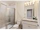 Clean bathroom with granite vanity and walk-in shower at 7143 Oakmoss Loop, Davenport, FL 33837