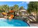 Orange waterslide cascading into a refreshing pool below at 7143 Oakmoss Loop, Davenport, FL 33837