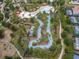 Aerial view of a relaxing lazy river winding through lush landscaping at 7143 Oakmoss Loop, Davenport, FL 33837