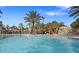 Refreshing community pool with a waterslide and plenty of lounge space at 7143 Oakmoss Loop, Davenport, FL 33837