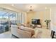 Living room with a comfortable sofa, a large TV, and access to a patio at 7143 Oakmoss Loop, Davenport, FL 33837