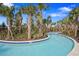 Relaxing lazy river with lush tropical landscaping at 7143 Oakmoss Loop, Davenport, FL 33837