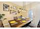 Dining area with wood table and yellow placemats at 7143 Oakmoss Loop, Davenport, FL 33837