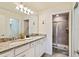 Double vanity bathroom with a walk-in shower at 7143 Oakmoss Loop, Davenport, FL 33837
