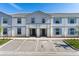 Two-story townhome with light grey siding and blue shutters at 7143 Oakmoss Loop, Davenport, FL 33837