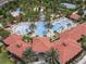 Aerial view of resort-style pool with water features, slides, and a lazy river at 7143 Oakmoss Loop, Davenport, FL 33837