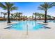 Large resort-style pool with a waterslide and a rock waterfall feature at 7143 Oakmoss Loop, Davenport, FL 33837