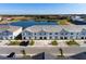 Aerial view of townhomes near a lake at 7143 Oakmoss Loop, Davenport, FL 33837