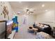 Upstairs bonus area with a sofa and TV at 7143 Oakmoss Loop, Davenport, FL 33837