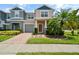 Two-story house with two-car garage and landscaping at 889 Park Grove Ct, Orlando, FL 32828