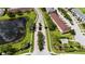 Gated community entrance with a pond and lush landscaping at 889 Park Grove Ct, Orlando, FL 32828