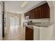 Kitchen with dark wood cabinets, tile floors and a breakfast bar at 889 Park Grove Ct, Orlando, FL 32828