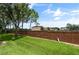 Landscaped backyard with brick wall and green lawn at 889 Park Grove Ct, Orlando, FL 32828