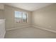 Empty carpeted bedroom with a window and neutral walls at 889 Park Grove Ct, Orlando, FL 32828