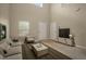 Living room with large windows, neutral walls, and a cozy seating area at 889 Park Grove Ct, Orlando, FL 32828