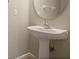 Small bathroom with pedestal sink and tiled floor at 889 Park Grove Ct, Orlando, FL 32828