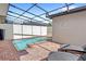 Private screened-in pool with brick pavers and lounge chairs at 2015 Majorca Drive, Kissimmee, FL 34747