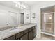 Double vanity bathroom with granite countertop and a large shower at 2015 Majorca Drive, Kissimmee, FL 34747