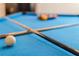 Close-up view of a pool table with balls and cues at 4637 Target Blvd, Kissimmee, FL 34746