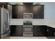 Modern kitchen with dark cabinetry and stainless steel appliances at 4637 Target Blvd, Kissimmee, FL 34746