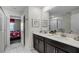 Double vanity bathroom with dark brown cabinets and a walk-in shower at 4637 Target Blvd, Kissimmee, FL 34746