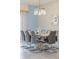 Bright dining room features a large table with seating for eight and a modern chandelier at 4637 Target Blvd, Kissimmee, FL 34746