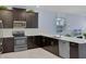Modern kitchen with dark cabinetry and quartz countertops at 4637 Target Blvd, Kissimmee, FL 34746