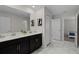 Shared bathroom with double vanity and marble-look tile at 4637 Target Blvd, Kissimmee, FL 34746
