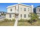 Modern two-story home with light beige siding and a red door at 4637 Target Blvd, Kissimmee, FL 34746
