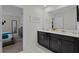 Double vanity bathroom with dark brown cabinets and white marble floors at 4637 Target Blvd, Kissimmee, FL 34746