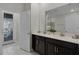 Double vanity bathroom with dark brown cabinets and white tile floors at 4637 Target Blvd, Kissimmee, FL 34746
