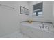 Relaxing bathroom with soaking tub and marble tile at 4637 Target Blvd, Kissimmee, FL 34746