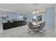 Open concept dining room with seating for eight adjacent to living room at 4637 Target Blvd, Kissimmee, FL 34746