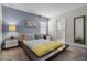 Bedroom with a platform bed and grey and yellow bedding at 4637 Target Blvd, Kissimmee, FL 34746
