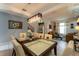 Elegant dining room features a spacious table with modern lighting at 5237 Oakbourne Ave, Davenport, FL 33837