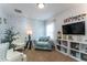 Cozy sitting area with comfortable chairs, bookshelves, and TV at 5237 Oakbourne Ave, Davenport, FL 33837