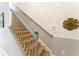 Elegant staircase with unique wall decor and gold accents at 5237 Oakbourne Ave, Davenport, FL 33837