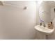 Clean and simple bathroom with pedestal sink and oval mirror at 5237 Oakbourne Ave, Davenport, FL 33837