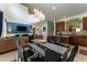Kitchen dining area with black glass table and modern chandelier at 5237 Oakbourne Ave, Davenport, FL 33837