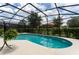 Refreshing kidney-shaped pool with a screened enclosure at 5237 Oakbourne Ave, Davenport, FL 33837