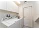 Laundry room with Whirlpool washer and dryer, plus storage cabinets at 5237 Oakbourne Ave, Davenport, FL 33837
