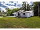 Side view of a new gray house with well-manicured landscaping at 2660 S Park Ave, Sanford, FL 32773