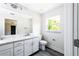 Modern bathroom featuring a toilet, vanity, and large mirror at 2660 S Park Ave, Sanford, FL 32773