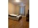 Simple bedroom with a bed, window, and wood flooring at 8710 Saratoga Inlet Dr # 305, Orlando, FL 32829