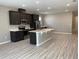 Modern kitchen with stainless steel appliances and an island at 8073 Cherrystone St, Leesburg, FL 34748